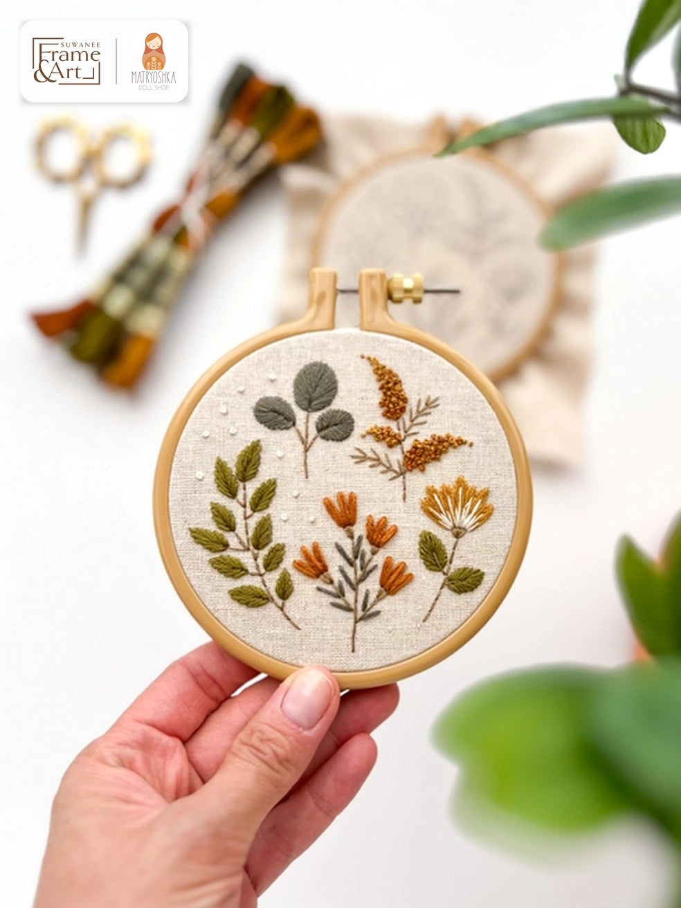 Fall Botanicals embroidery hoop with stitched sprigs and wildflowers in sage, rust and gold on linen
