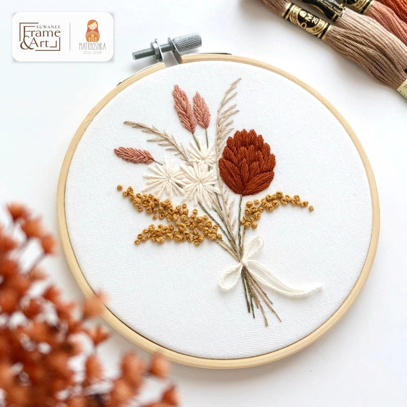 Flowers Bouquet embroidery hoop with a dried-flower bouquet in terracotta, blush and gold tied with a white bow