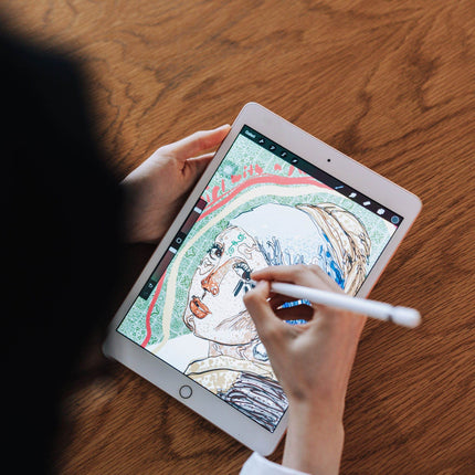 Artist drawing a portrait illustration in Procreate on an iPad with a stylus