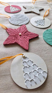 Close-up of a pink textured plaster star ornament with a small gold star center