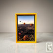 Suwanee Frame & Art hot air balloon landscape print in a bright yellow frame. Cappadocia scene with multiple balloons over canyons.